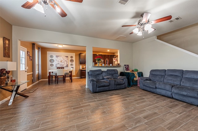 living room with ceiling fan and hardwood / wood-style flooring