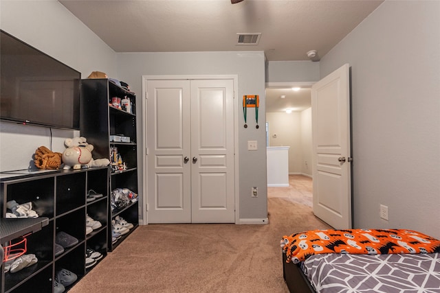 bedroom with a closet and light colored carpet