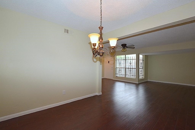 spare room with ceiling fan with notable chandelier, dark hardwood / wood-style floors, and a textured ceiling