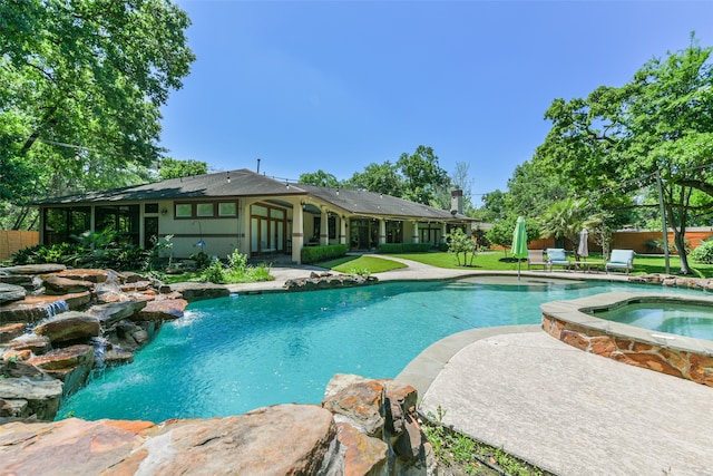 view of pool with a patio, an in ground hot tub, and pool water feature