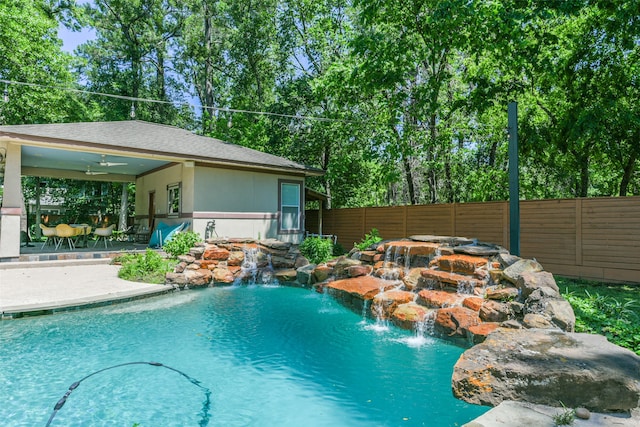 view of pool with a patio area, ceiling fan, and pool water feature