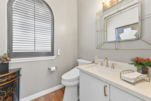 bathroom featuring vanity, toilet, and hardwood / wood-style floors