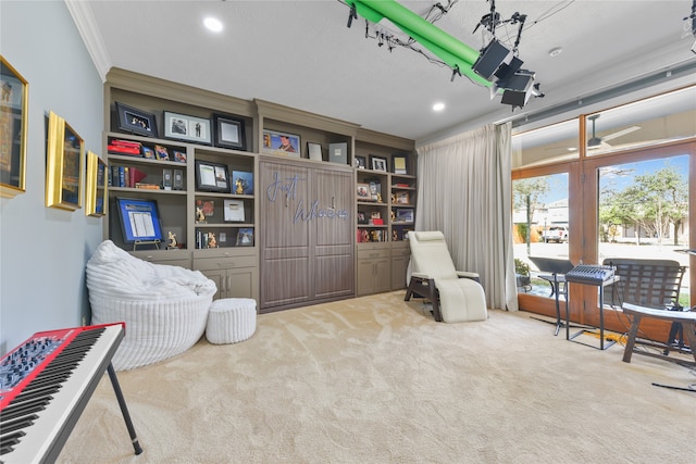 sitting room featuring ornamental molding and light carpet