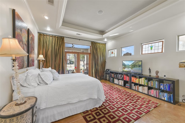 tiled bedroom featuring a raised ceiling, ornamental molding, and french doors