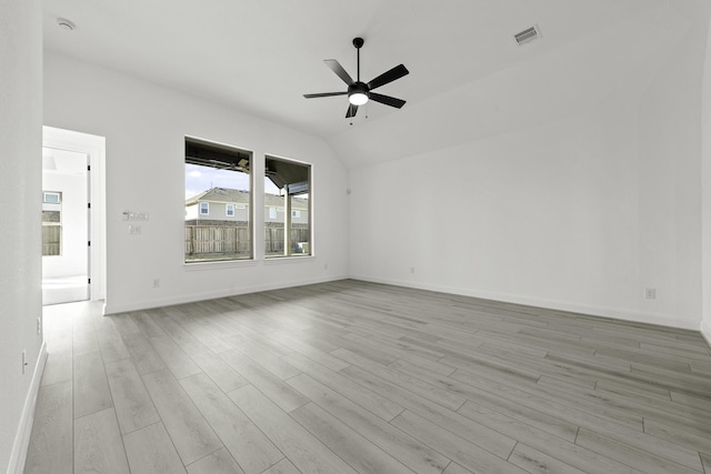 empty room featuring lofted ceiling, light wood-type flooring, and ceiling fan