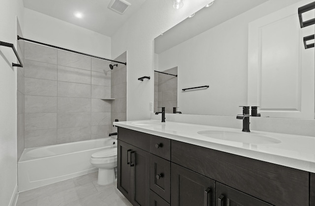 full bathroom with tiled shower / bath combo, vanity, and toilet