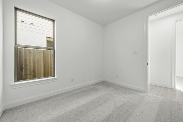 empty room featuring light carpet