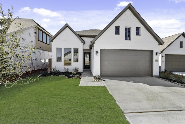 view of front of property featuring a garage and a front lawn