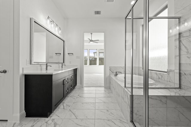 bathroom with vanity and tiled bath