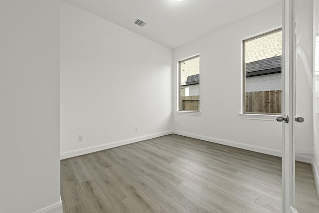 spare room with light hardwood / wood-style floors