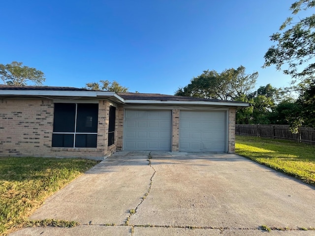 view of front of home with a garage and a front lawn