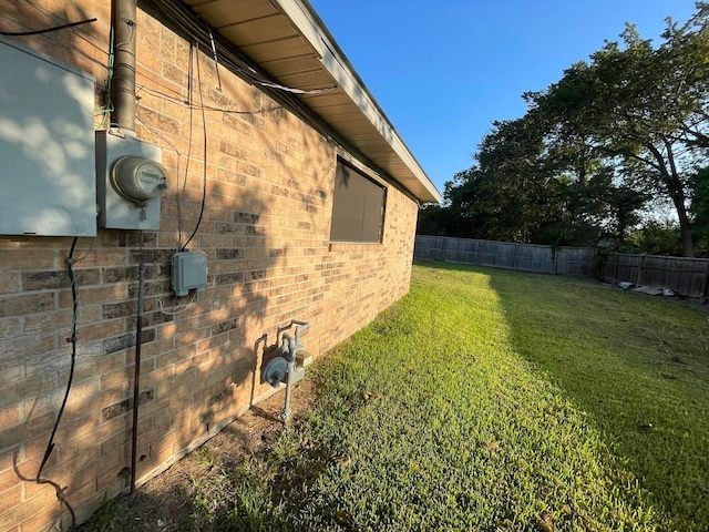 view of side of home with a lawn