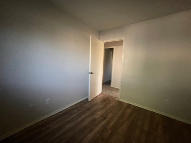 empty room featuring dark wood-type flooring