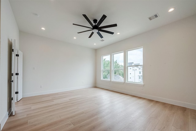 spare room with light hardwood / wood-style flooring and ceiling fan