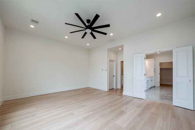 empty room with light hardwood / wood-style floors and ceiling fan