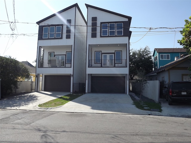 contemporary home with a garage and a balcony