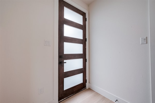 doorway with light wood-type flooring