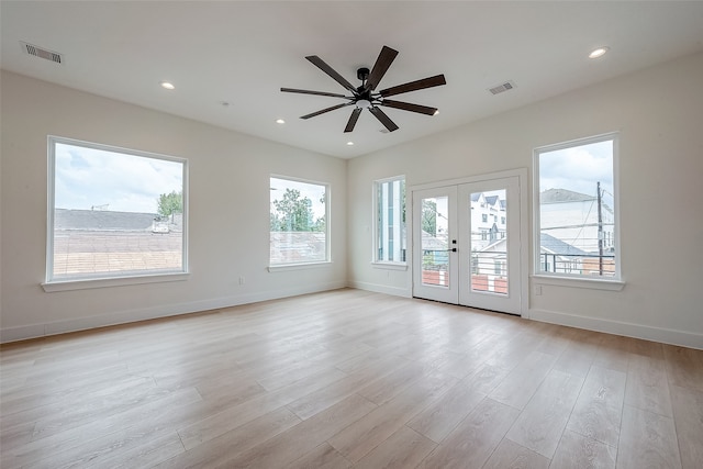 unfurnished room with french doors, light hardwood / wood-style flooring, and a wealth of natural light