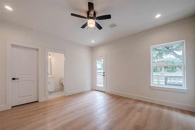 empty room with light wood-type flooring, ceiling fan, and a healthy amount of sunlight