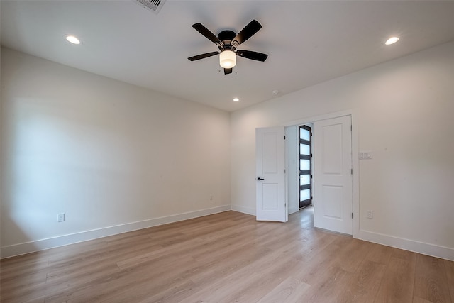 spare room featuring ceiling fan and light hardwood / wood-style floors