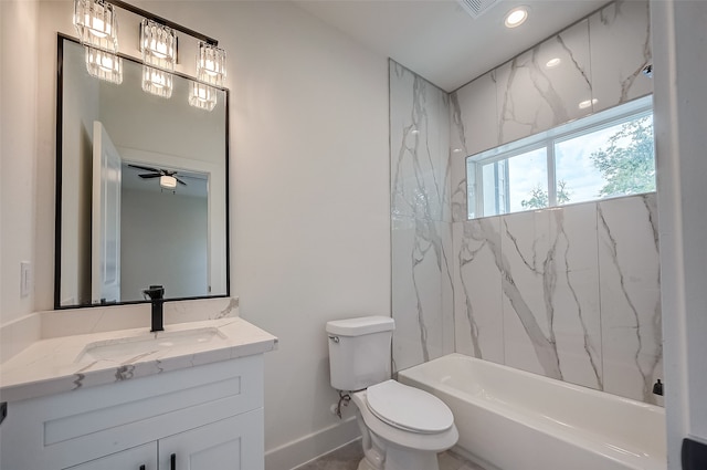 full bathroom with ceiling fan, tiled shower / bath, vanity, and toilet