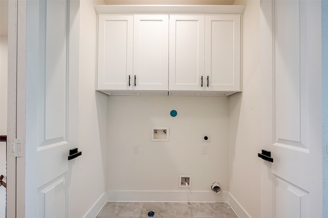 laundry room with washer hookup, hookup for an electric dryer, gas dryer hookup, and cabinets