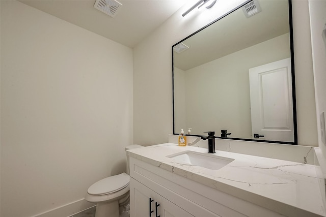 bathroom featuring toilet, tile patterned flooring, and vanity