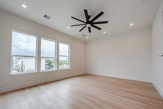 empty room featuring light hardwood / wood-style flooring and ceiling fan