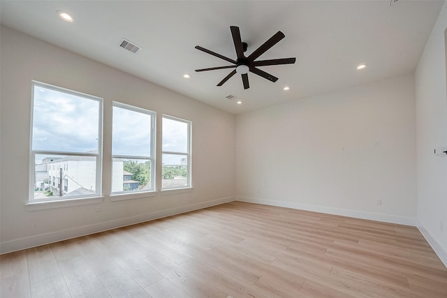 spare room with light hardwood / wood-style floors and ceiling fan