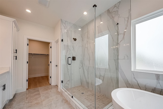 bathroom with vanity and plus walk in shower