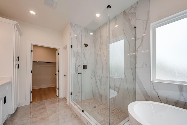 bathroom with vanity and plus walk in shower