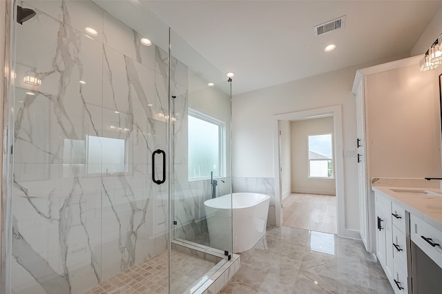 bathroom with shower with separate bathtub and vanity