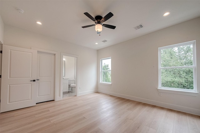 unfurnished bedroom featuring light hardwood / wood-style flooring, ensuite bath, and ceiling fan