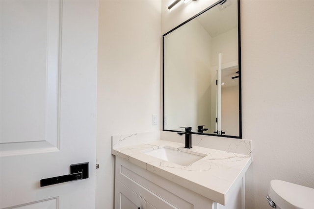 bathroom featuring toilet and vanity