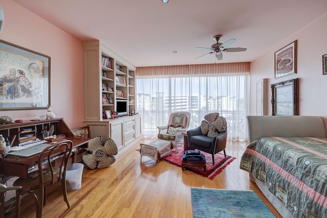 bedroom with ceiling fan and light hardwood / wood-style floors