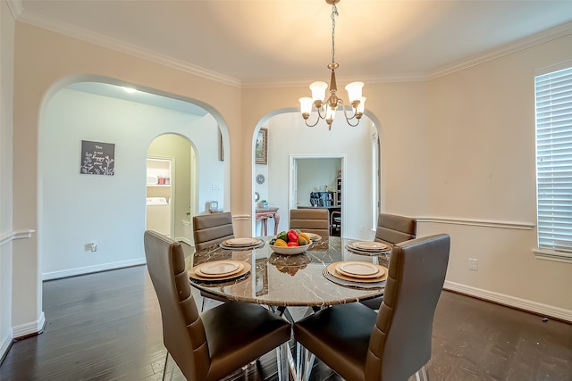 dining space featuring crown molding, dark wood-type flooring, and a notable chandelier