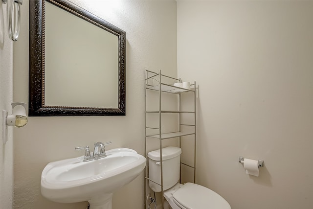 bathroom with toilet and sink