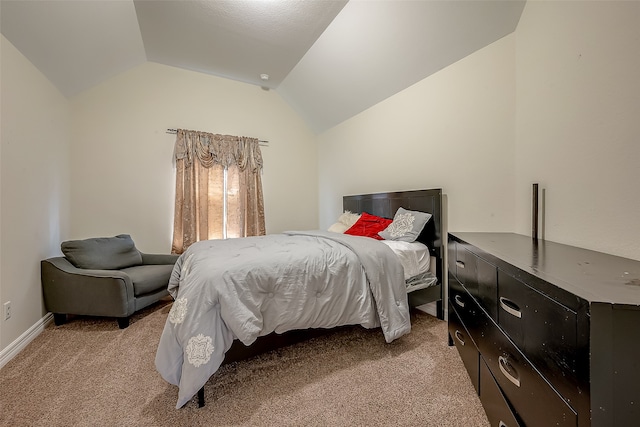 bedroom with lofted ceiling and carpet flooring