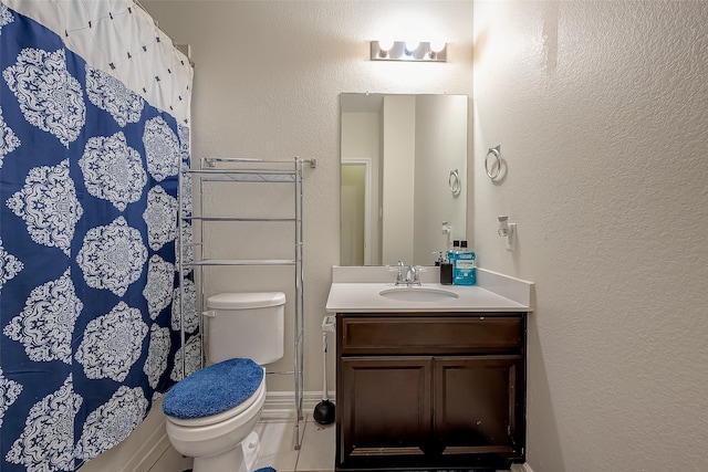 bathroom with vanity, toilet, and walk in shower