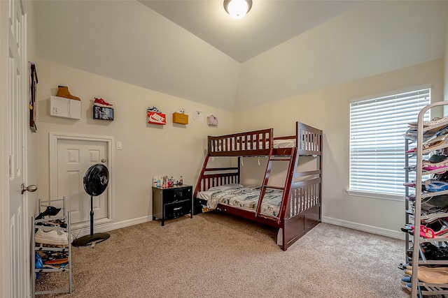 carpeted bedroom featuring lofted ceiling