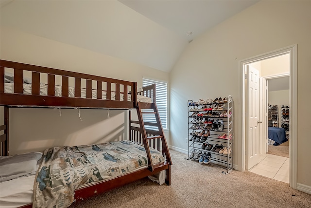 bedroom featuring lofted ceiling and light colored carpet