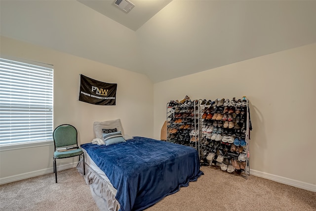 bedroom with light carpet and lofted ceiling