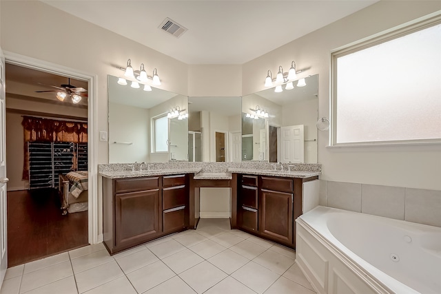 bathroom featuring tile patterned flooring, ceiling fan with notable chandelier, a wealth of natural light, and vanity