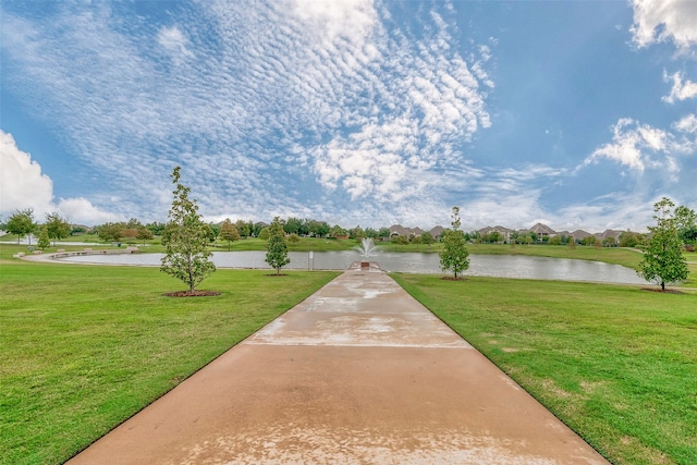 view of community featuring a water view and a lawn