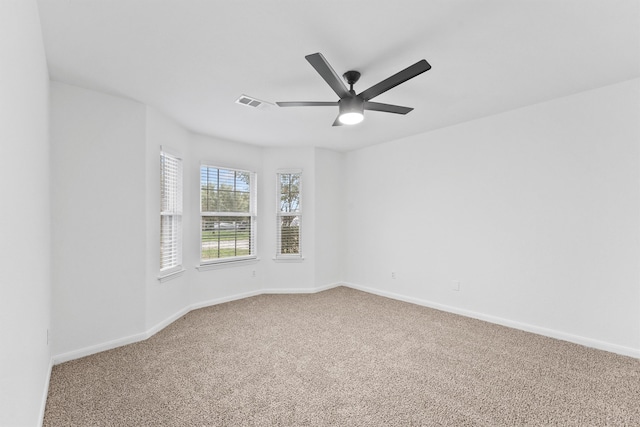 carpeted spare room with ceiling fan