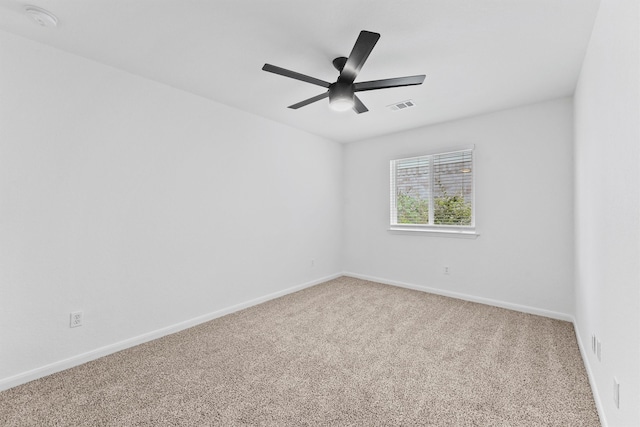 unfurnished room with ceiling fan and light carpet