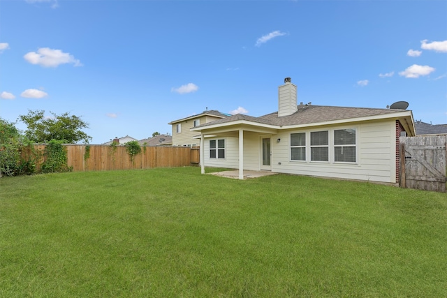 back of house with a lawn and a patio