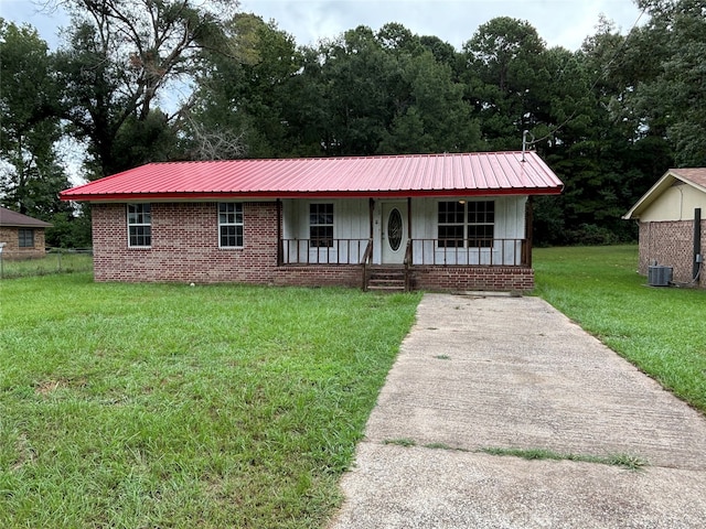 ranch-style home with a front yard, covered porch, and central air condition unit