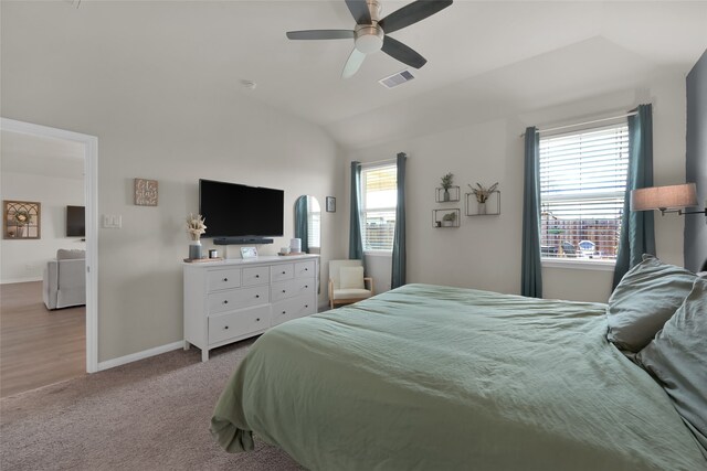 carpeted bedroom featuring lofted ceiling and ceiling fan