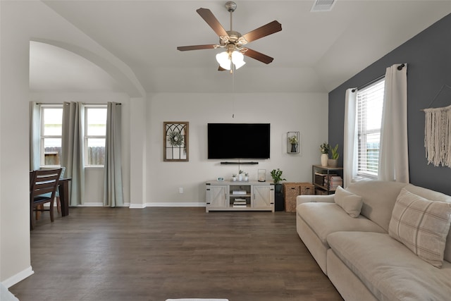 living room featuring lofted ceiling, ceiling fan, a wealth of natural light, and dark hardwood / wood-style floors